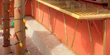 Bamboo poles with lights near a bamboo counter