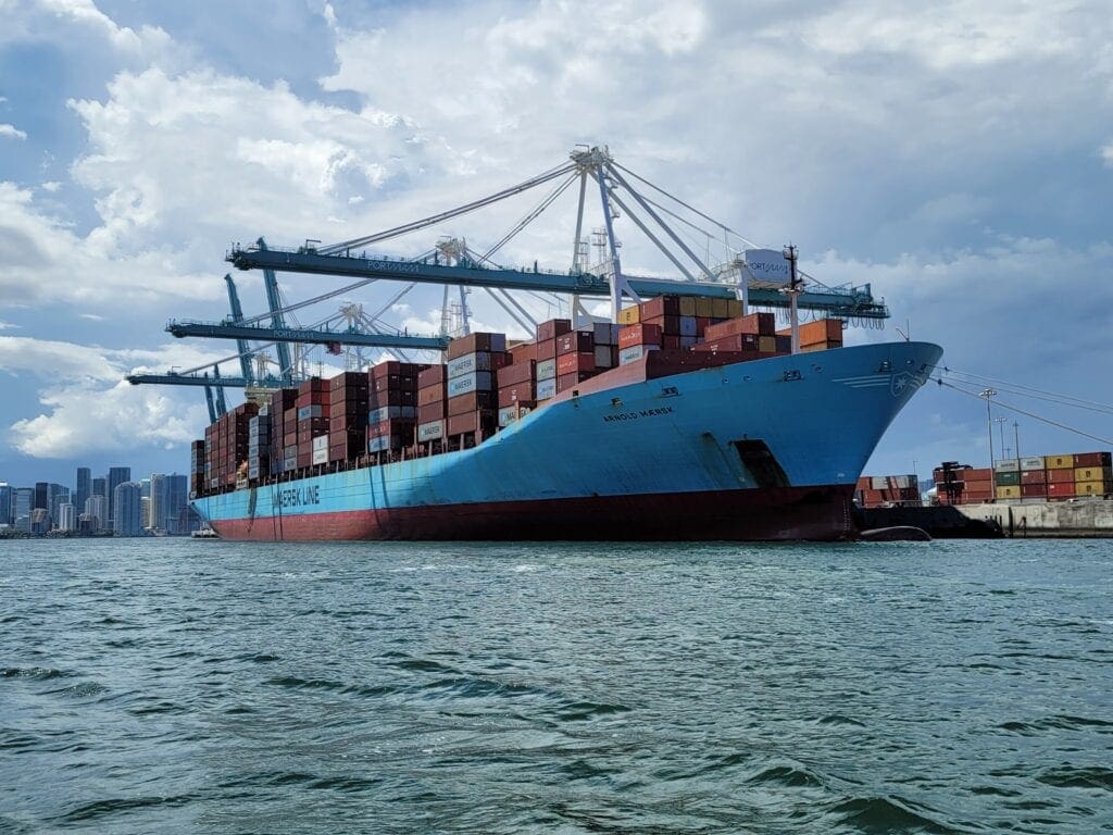 A large container ship docked in a body of water.