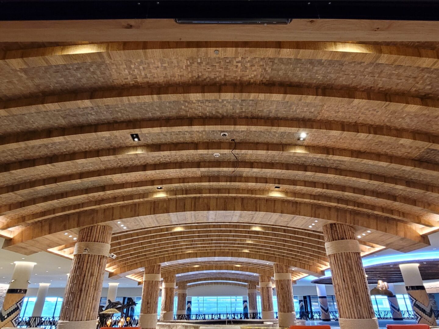 The lobby of a hotel with a wooden ceiling.