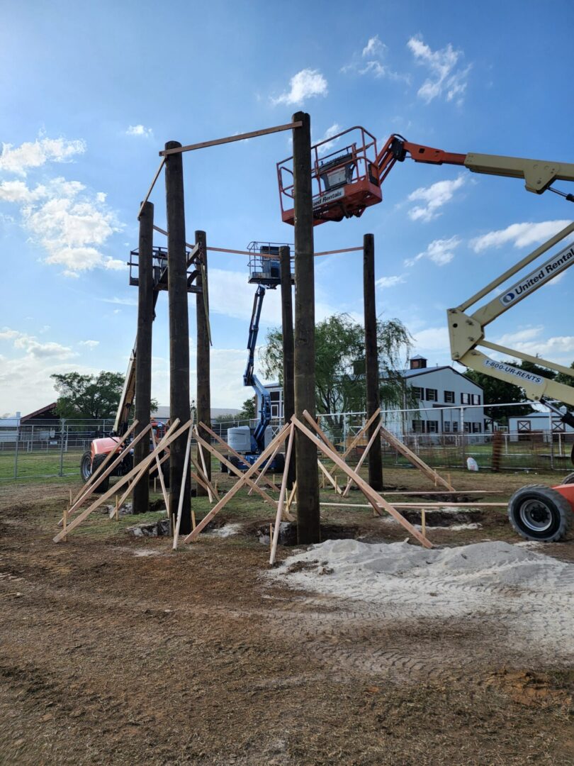 A tiki hut being constructed using lift platforms