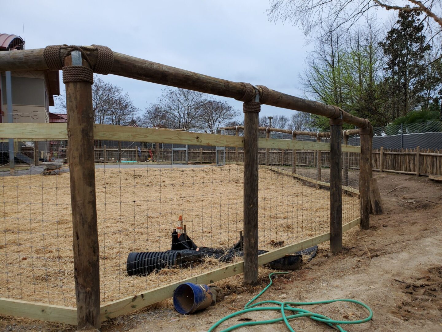 A wooden fence in a zoo.