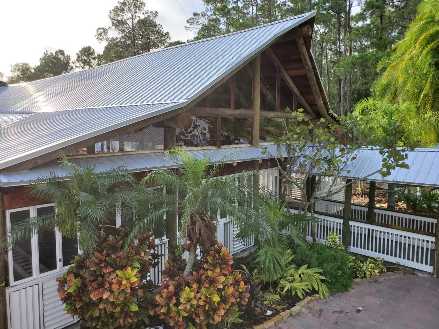 An aerial view of a house with a metal roof.