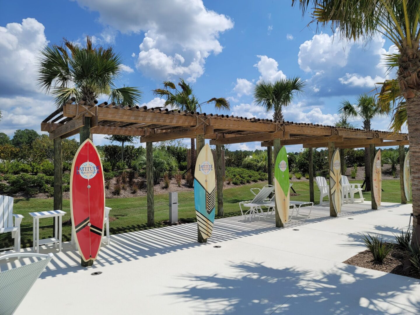 A group of surfboards are sitting on a wooden deck.