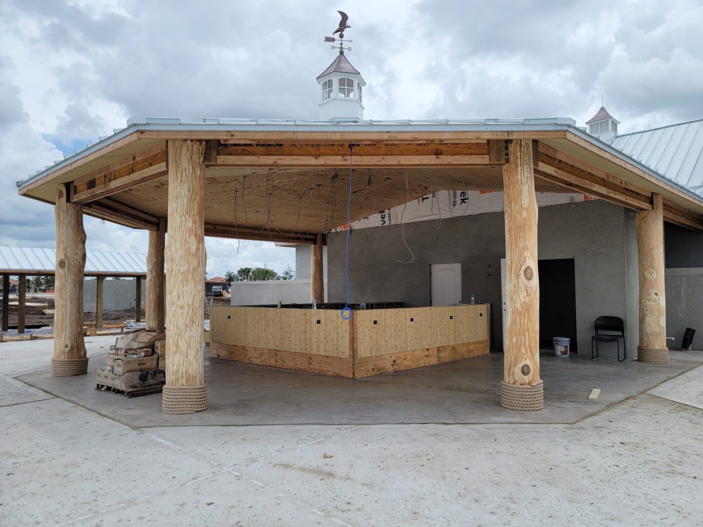 A wooden building with a bar and a clock.