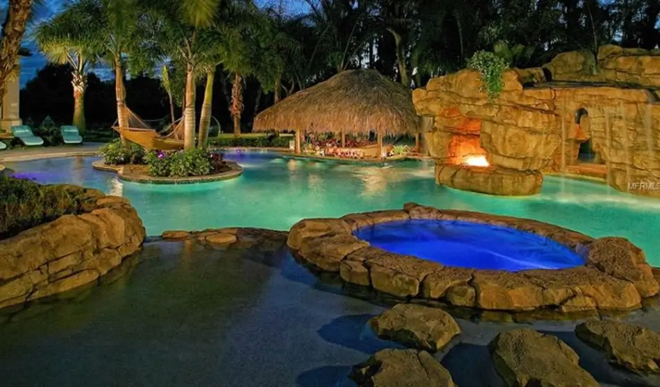 A tropical-themed swimming pool with lighting