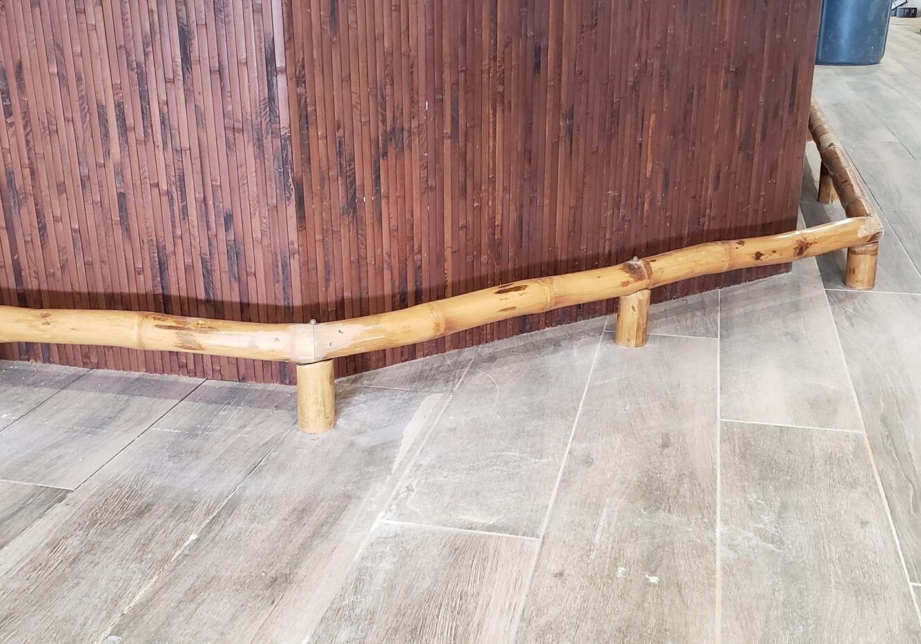 A wooden bench in a room with a wooden floor.