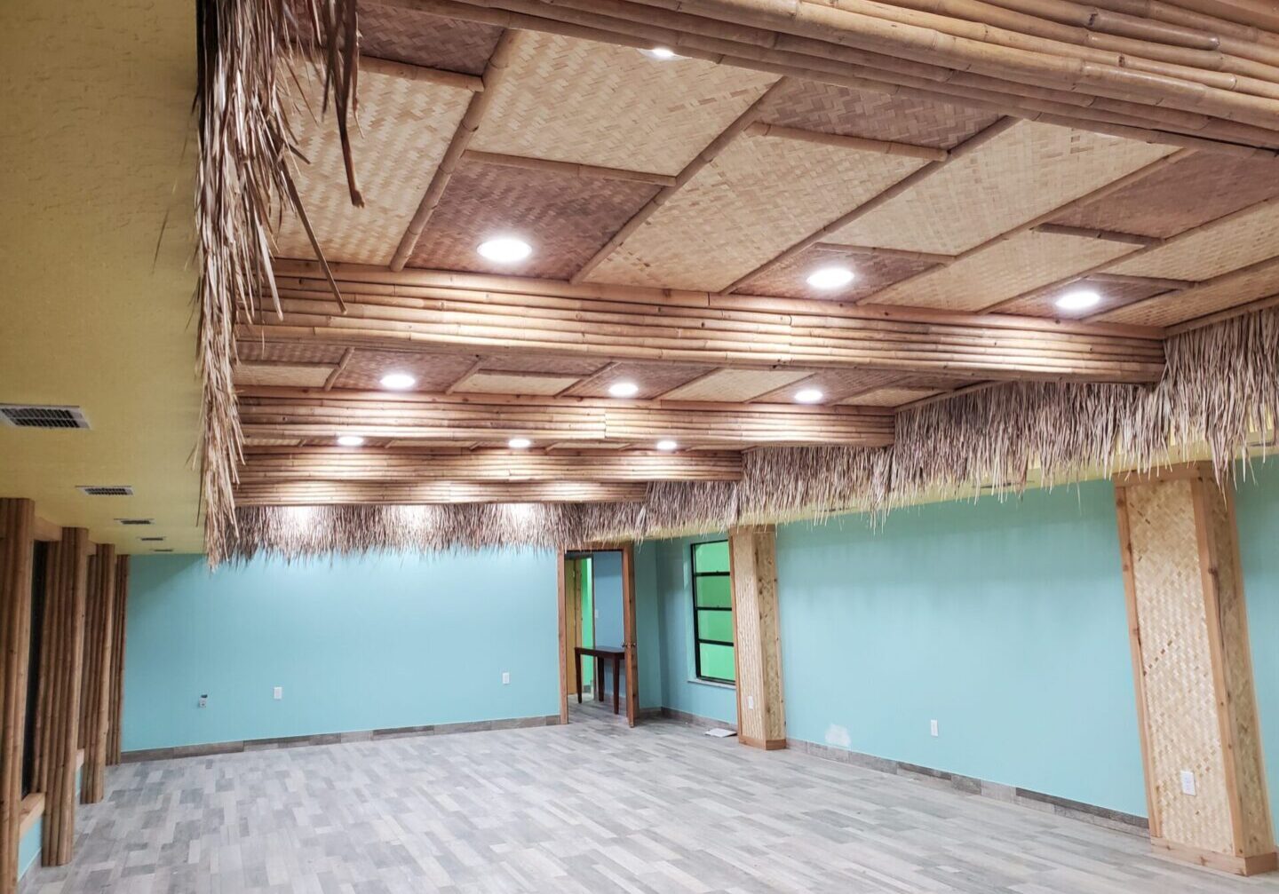 An empty room with a tiki ceiling.