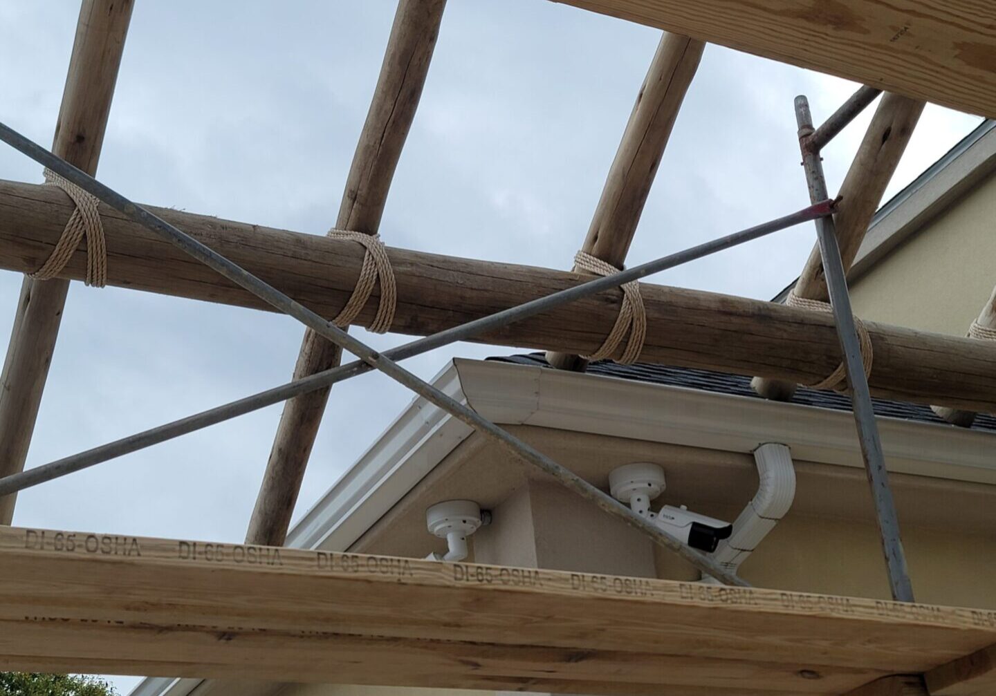 The roof of a house is being built with wooden beams.