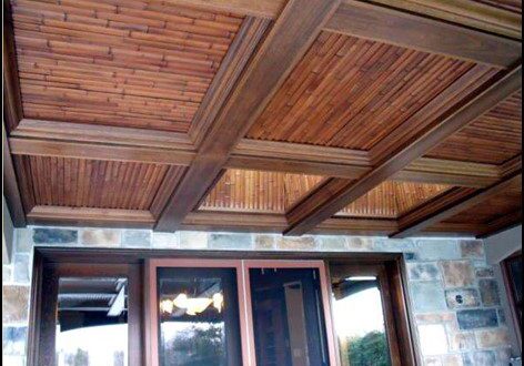 A wooden ceiling with wooden beams and a glass door.