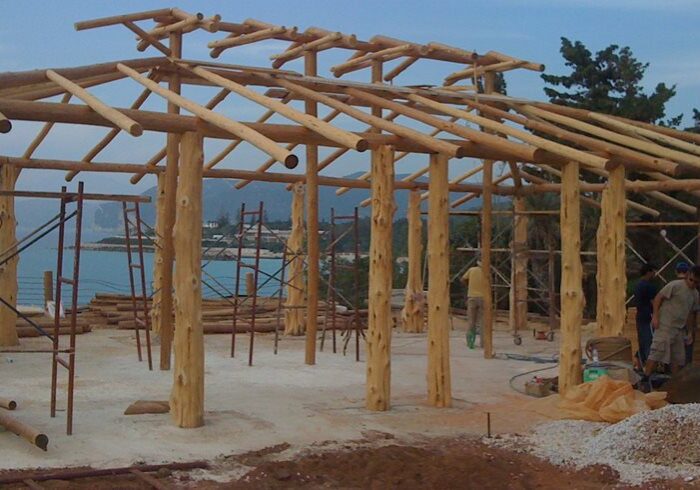A wooden structure is being built on the beach.